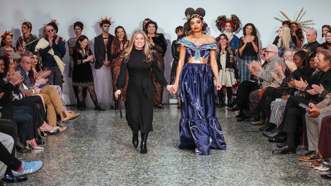 HCC Fashion Design student Tanya Roche walks with her model wearing her winning design “Hummingbird” in the Reengineer: Repurpose the Forgotten category.