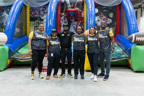Rec Crew posing in front of sport inflatable